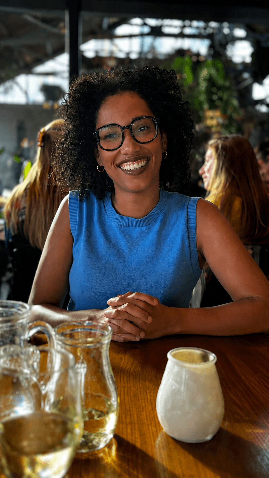 Susana smiling at a cafe table