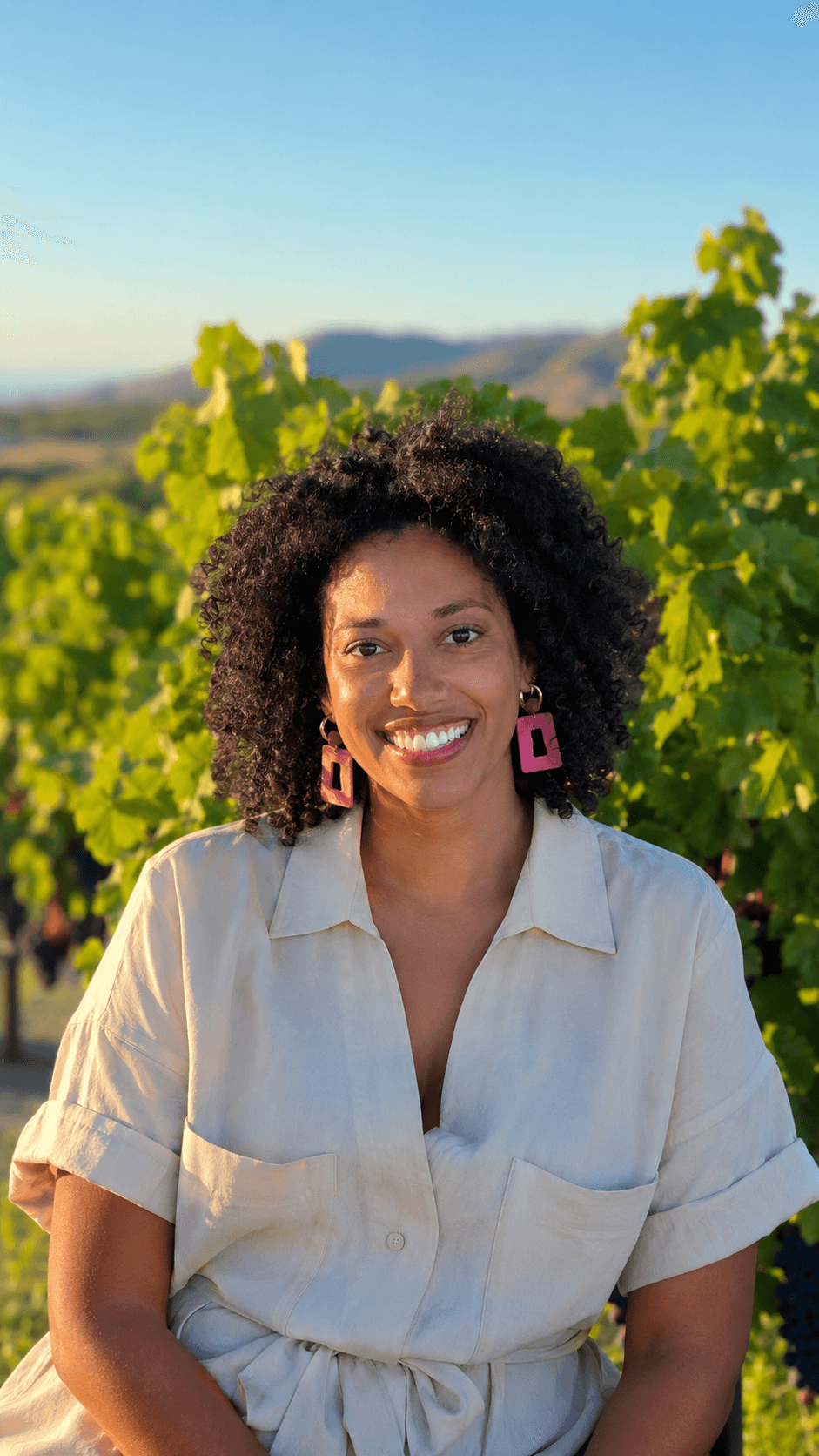 Susana smiling in a vineyard